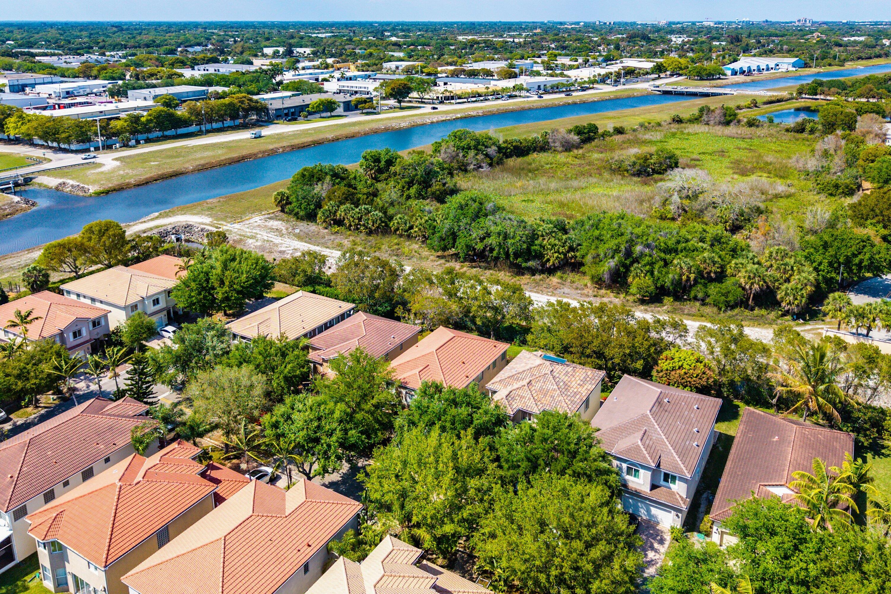 1509 Sage Wood Court Riviera Beach, FL 33404 - Photo 50 of 59 an aerial view of residential houses with outdoor space and river view