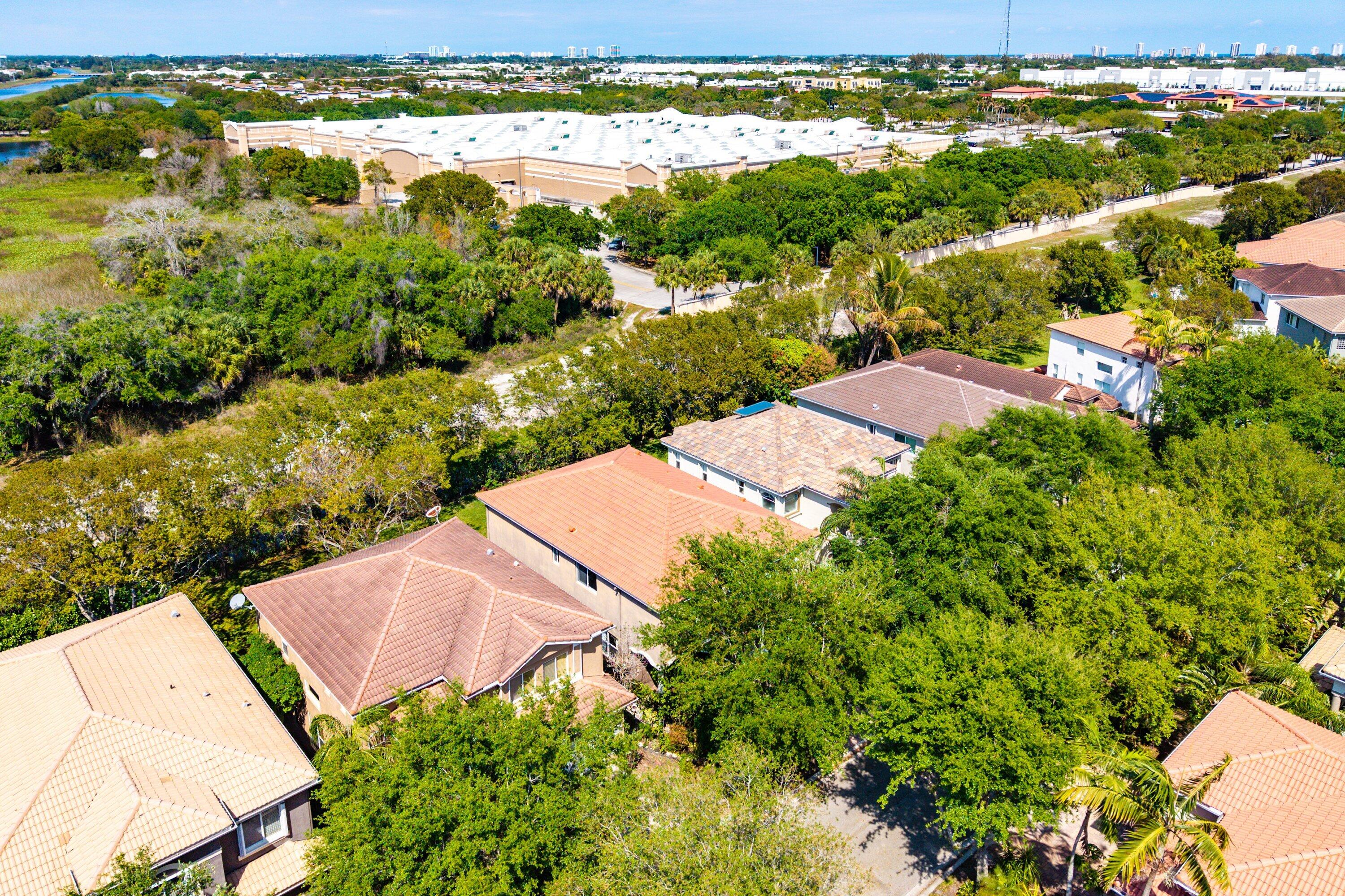 1509 Sage Wood Court Riviera Beach, FL 33404 - Photo 51 of 59 an aerial view of residential houses with outdoor space and trees all around