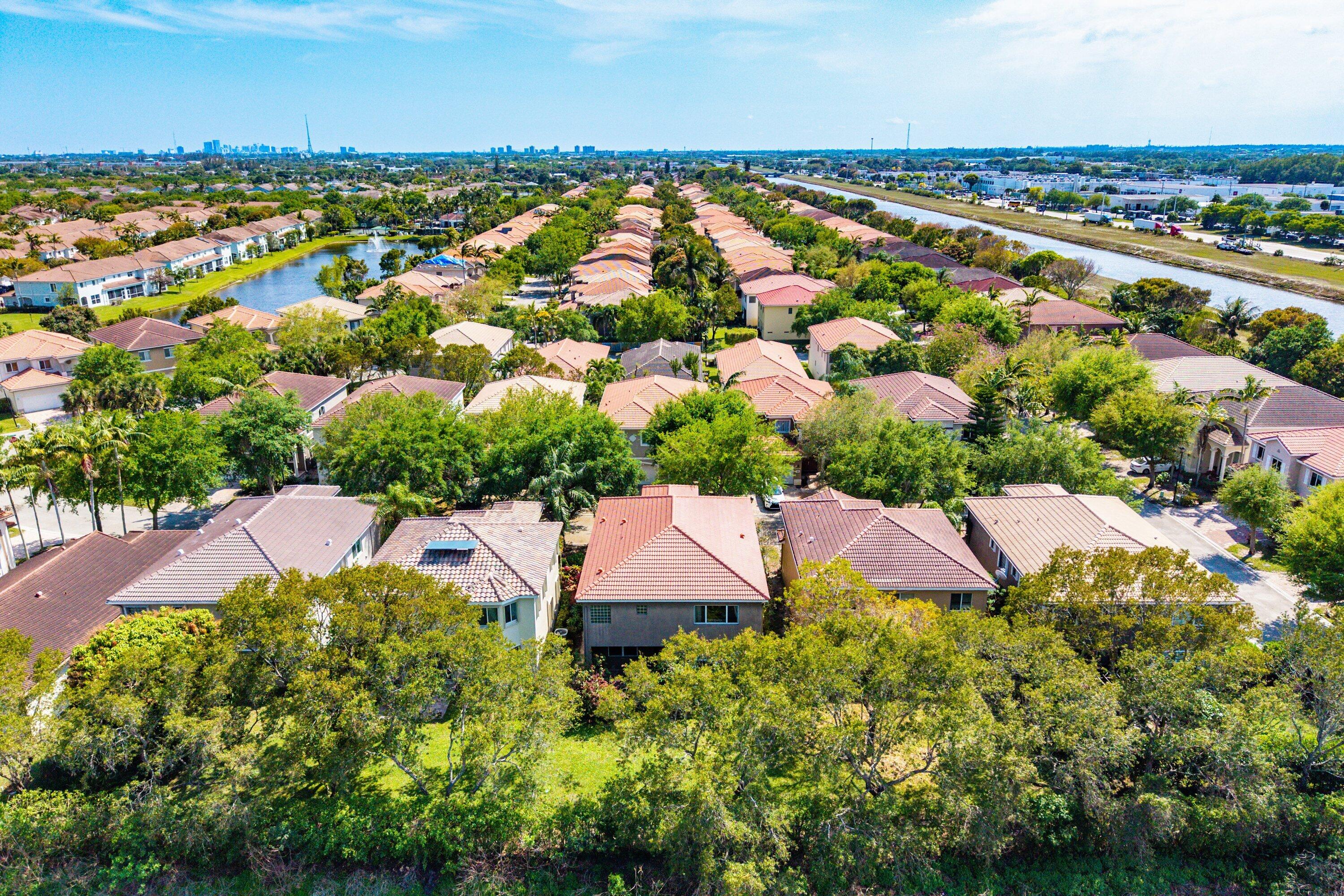 1509 Sage Wood Court Riviera Beach, FL 33404 - Photo 53 of 59 an aerial view of house with yard swimming pool and outdoor seating