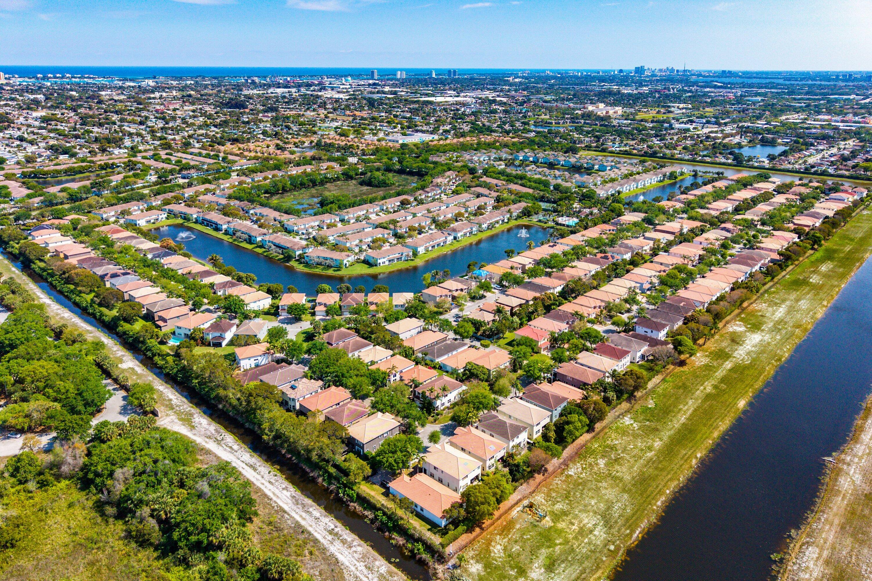 1509 Sage Wood Court Riviera Beach, FL 33404 - Photo 57 of 59 an aerial view of residential houses with outdoor space