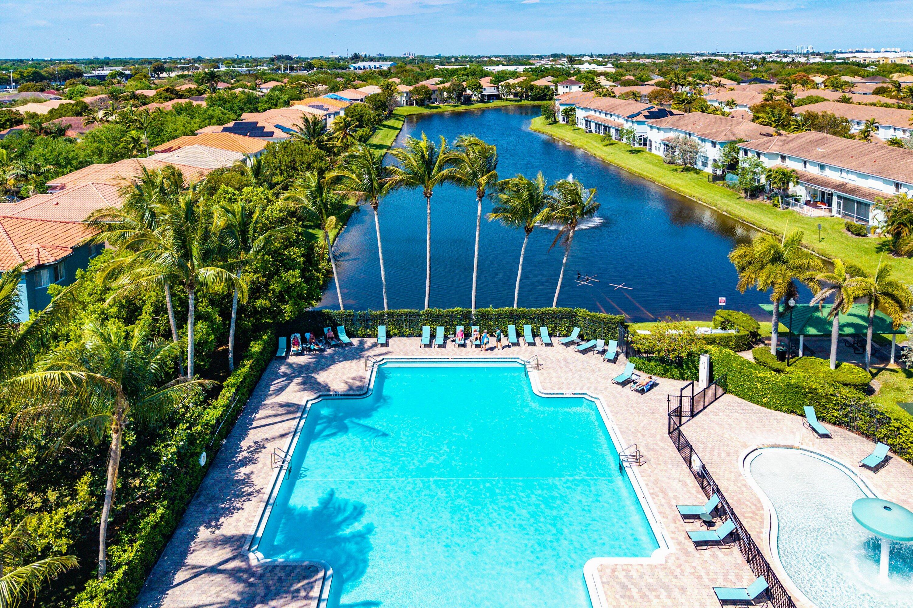 1509 Sage Wood Court Riviera Beach, FL 33404 - Photo 58 of 59 an aerial view of a house with a garden and lake view