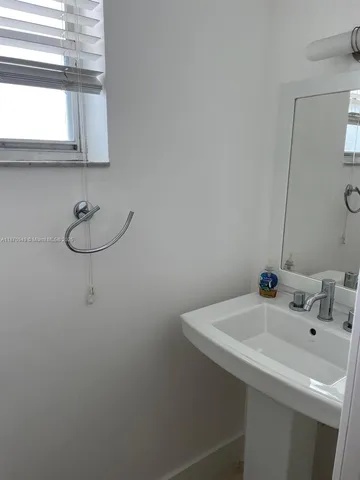 a bathroom with a sink and a window