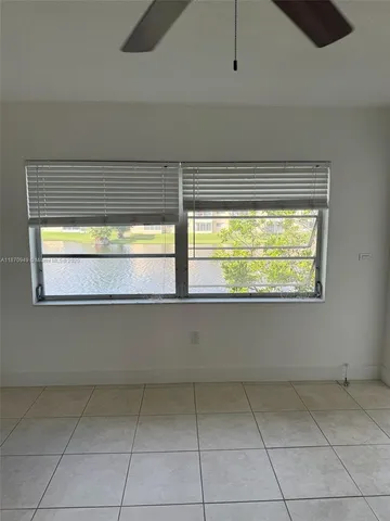 a view of kitchen with granite countertop cabinets and outdoor view