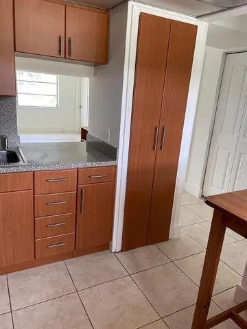 a kitchen with a sink window and cabinets