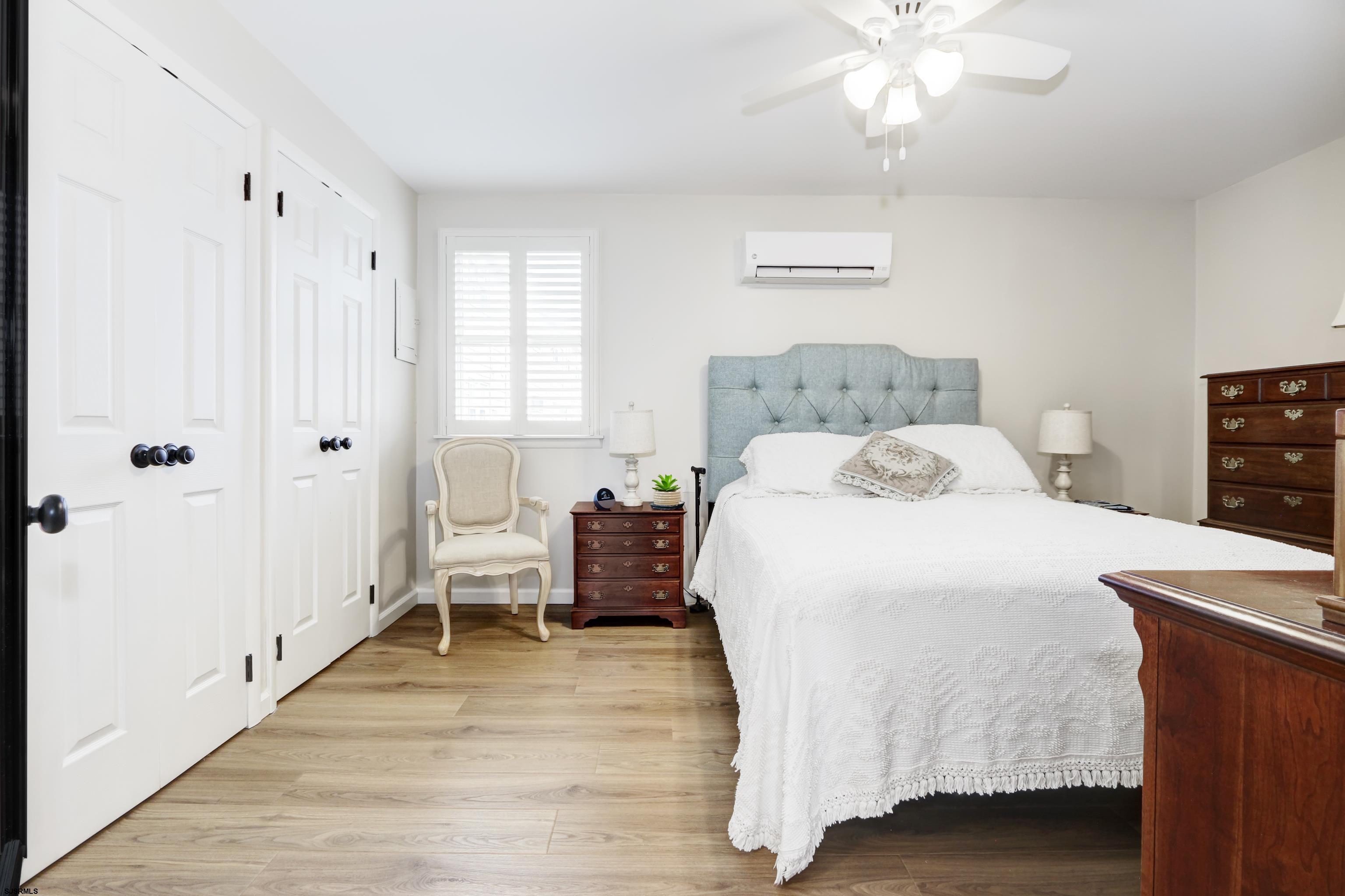 313 West Brigantine Avenue, Unit 4 Brigantine, NJ 08203 - Photo 12 of 38 a spacious bedroom with a bed and a chandelier