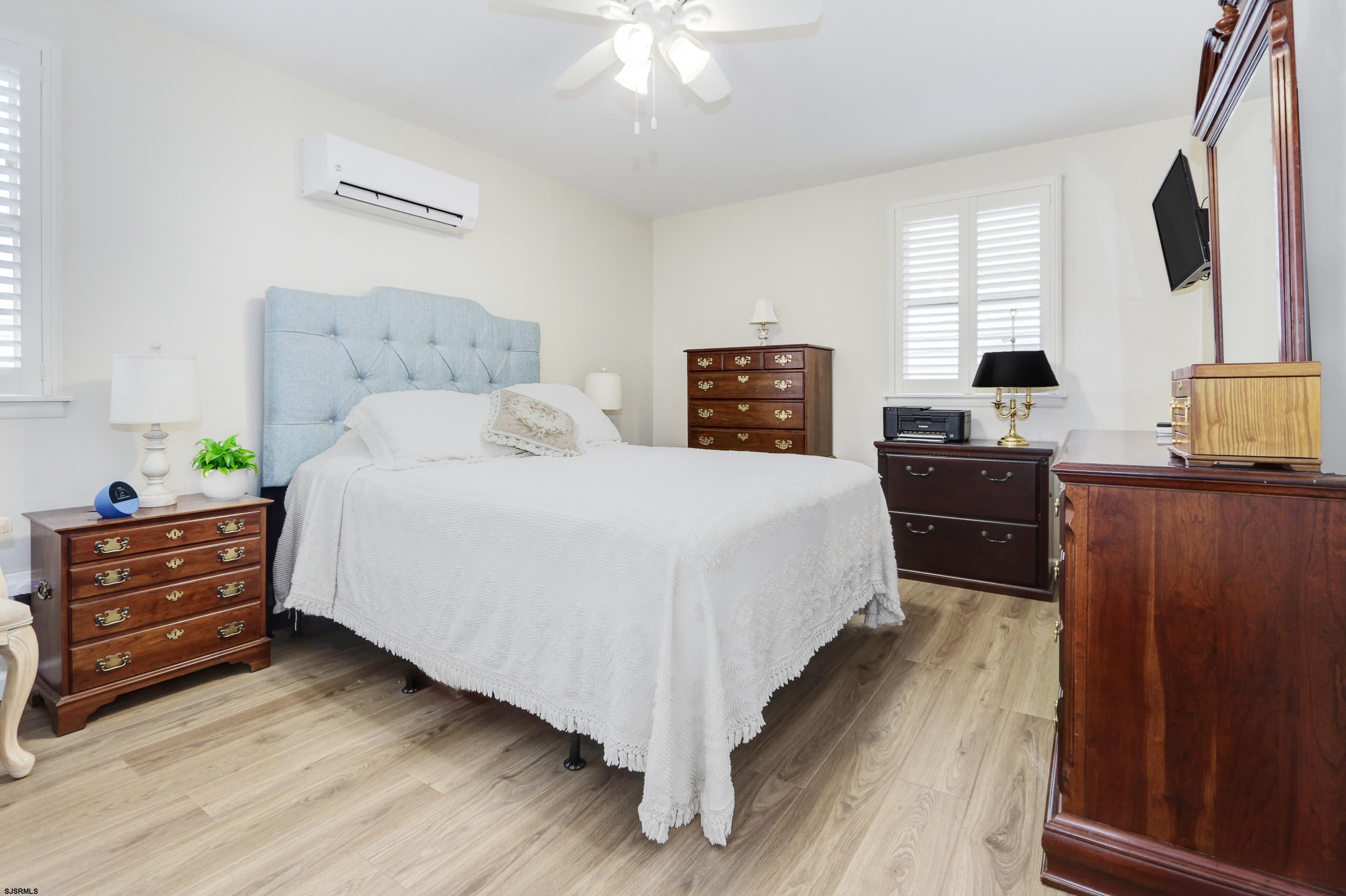 313 West Brigantine Avenue, Unit 4 Brigantine, NJ 08203 - Photo 13 of 38 a bedroom with a bed and a flat tv screen on dresser