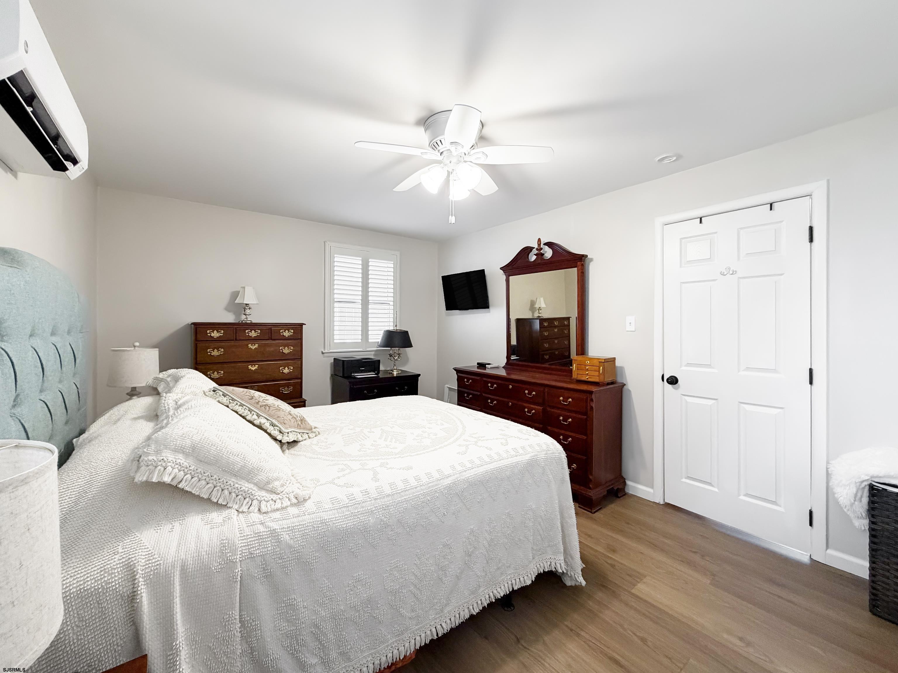 313 West Brigantine Avenue, Unit 4 Brigantine, NJ 08203 - Photo 14 of 38 a bedroom with a bed and a tv
