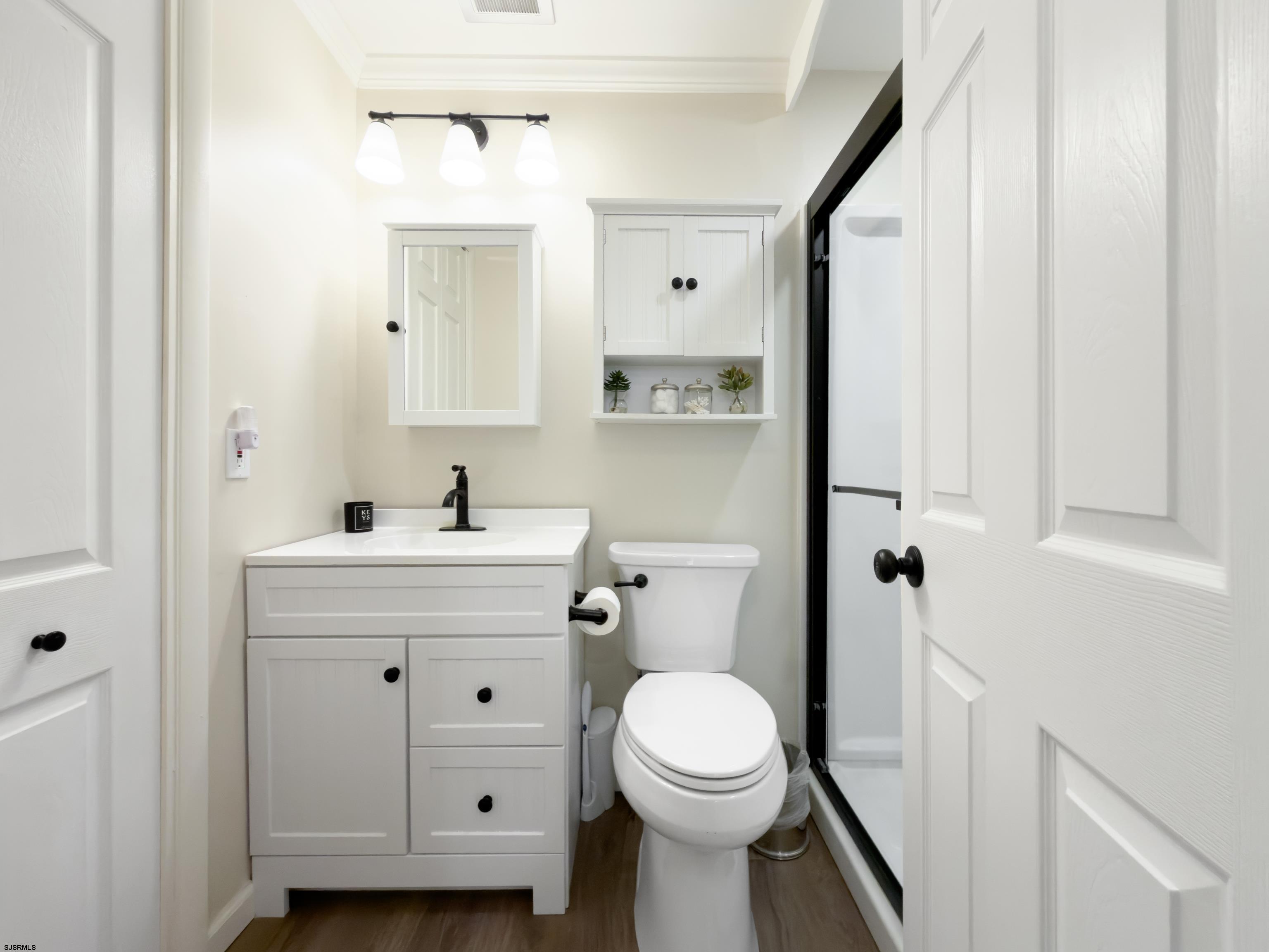 313 West Brigantine Avenue, Unit 4 Brigantine, NJ 08203 - Photo 15 of 38 a bathroom with a sink a toilet and shower