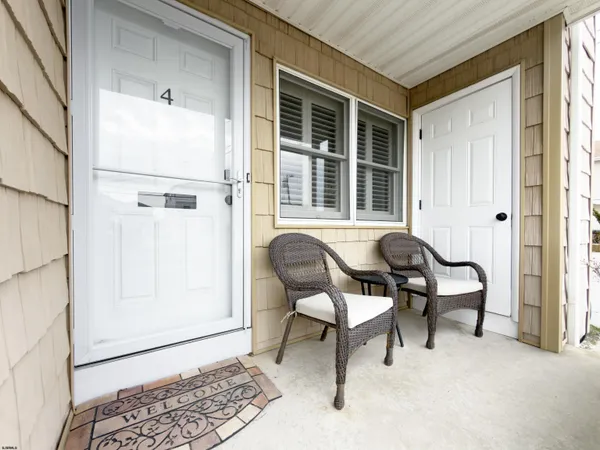 a balcony with table and chairs