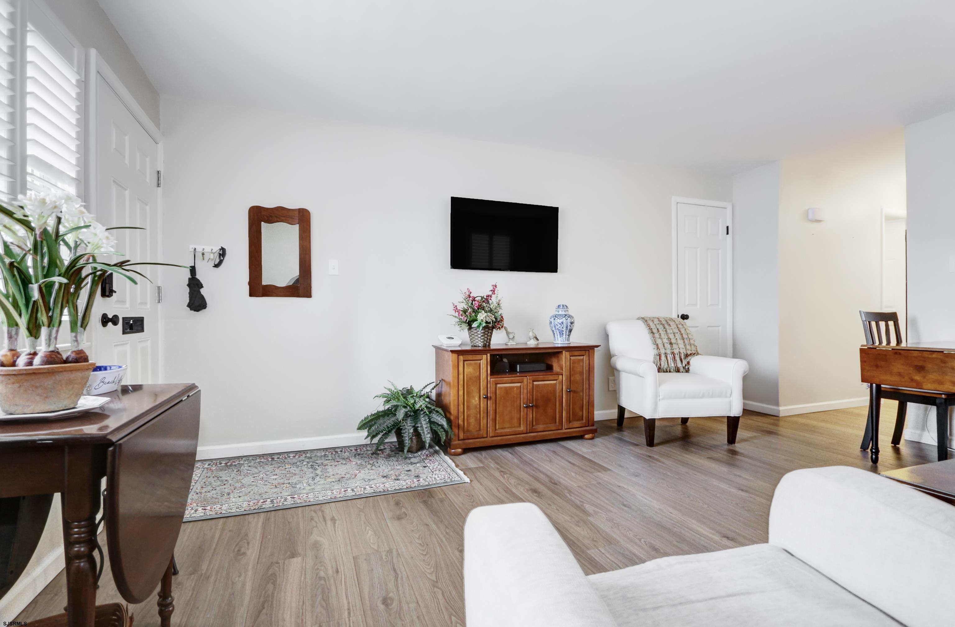 313 West Brigantine Avenue, Unit 4 Brigantine, NJ 08203 - Photo 8 of 38 a living room with furniture and a flat screen tv