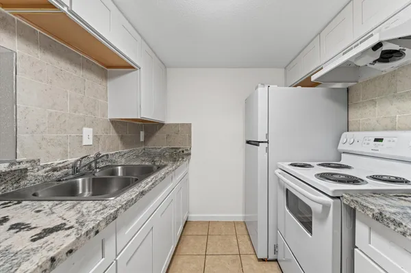 a kitchen that has a sink and a stove