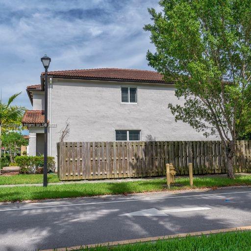 11850 Southwest 250th Terrace Homestead, FL 33032 - Photo 11 of 47 a front view of a house with a yard and a garage
