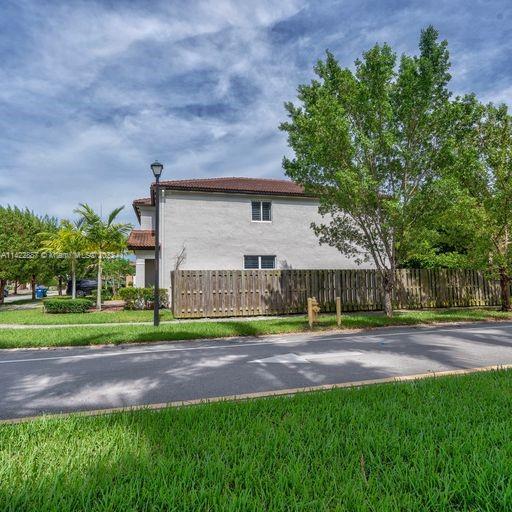 11850 Southwest 250th Terrace Homestead, FL 33032 - Photo 12 of 47 a front view of a house with a yard and trees