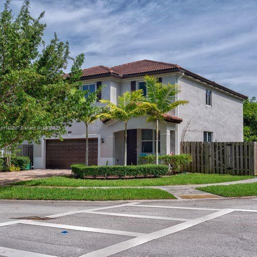 11850 Southwest 250th Terrace Homestead, FL 33032 - Photo 13 of 47 a front view of a house with a garden