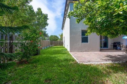 11850 Southwest 250th Terrace Homestead, FL 33032 - Photo 15 of 47 a view of a yard with plants and a large tree