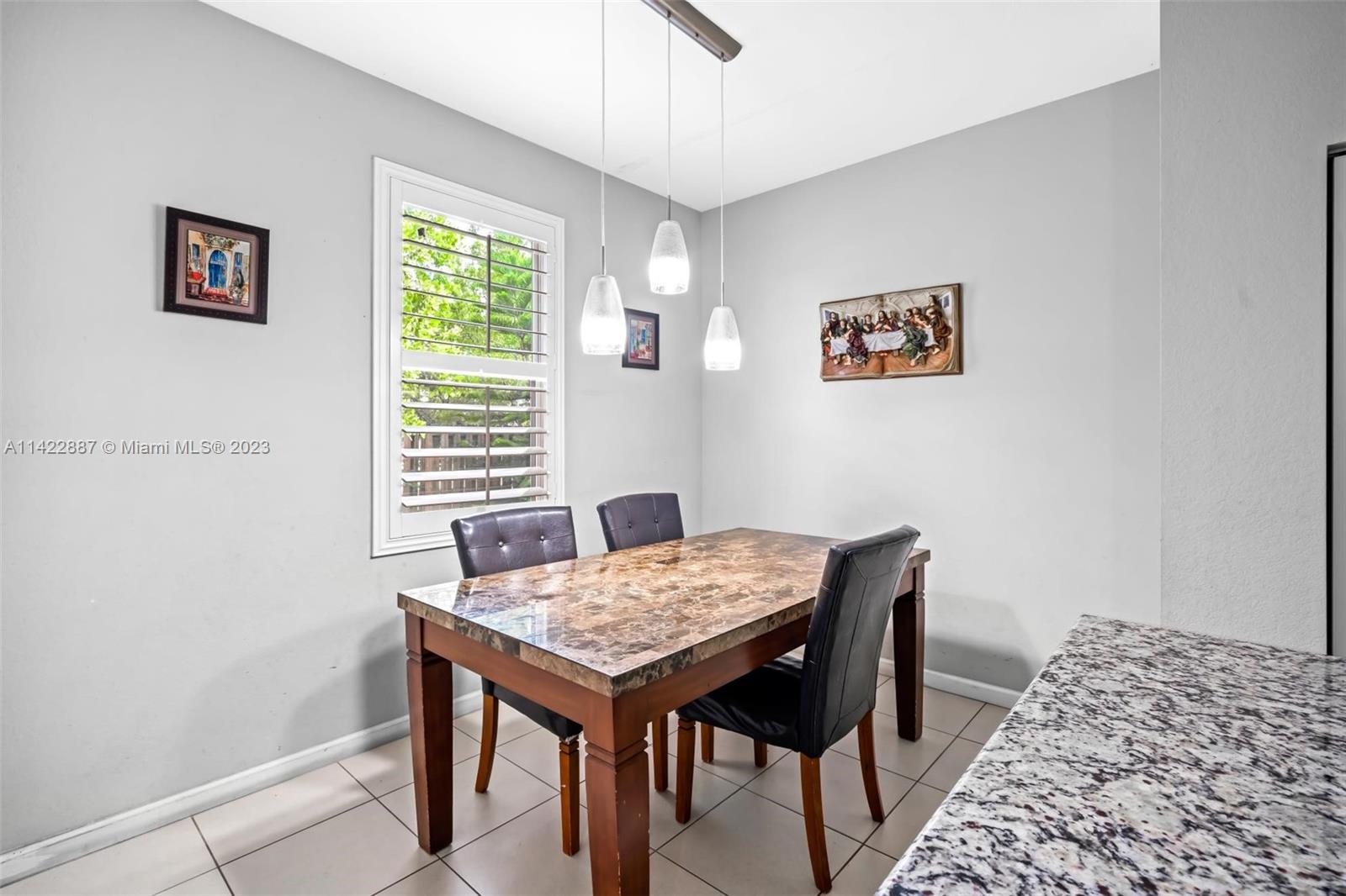11850 Southwest 250th Terrace Homestead, FL 33032 - Photo 21 of 47 a view of a dining room with a table and chairs