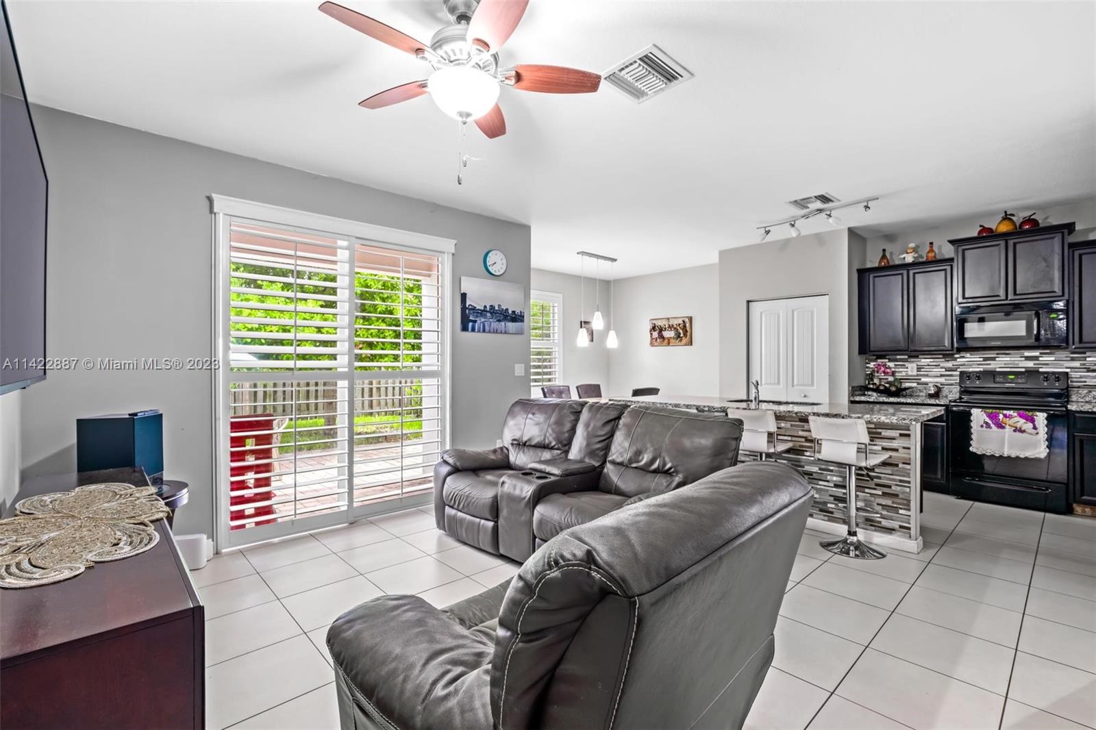 11850 Southwest 250th Terrace Homestead, FL 33032 - Photo 26 of 47 a living room with furniture and a flat screen tv