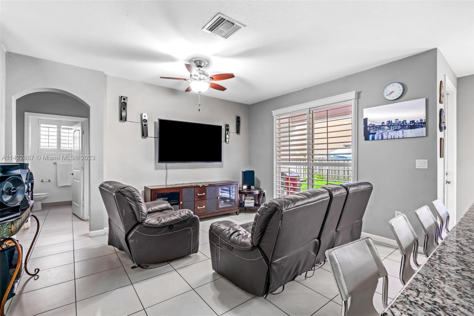 11850 Southwest 250th Terrace Homestead, FL 33032 - Photo 27 of 47 a living room with furniture a flat screen tv and a window