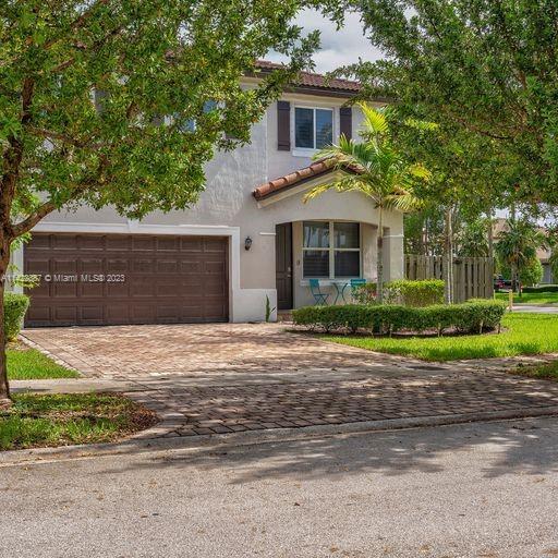11850 Southwest 250th Terrace Homestead, FL 33032 - Photo 3 of 47 a front view of a house with a yard and garage