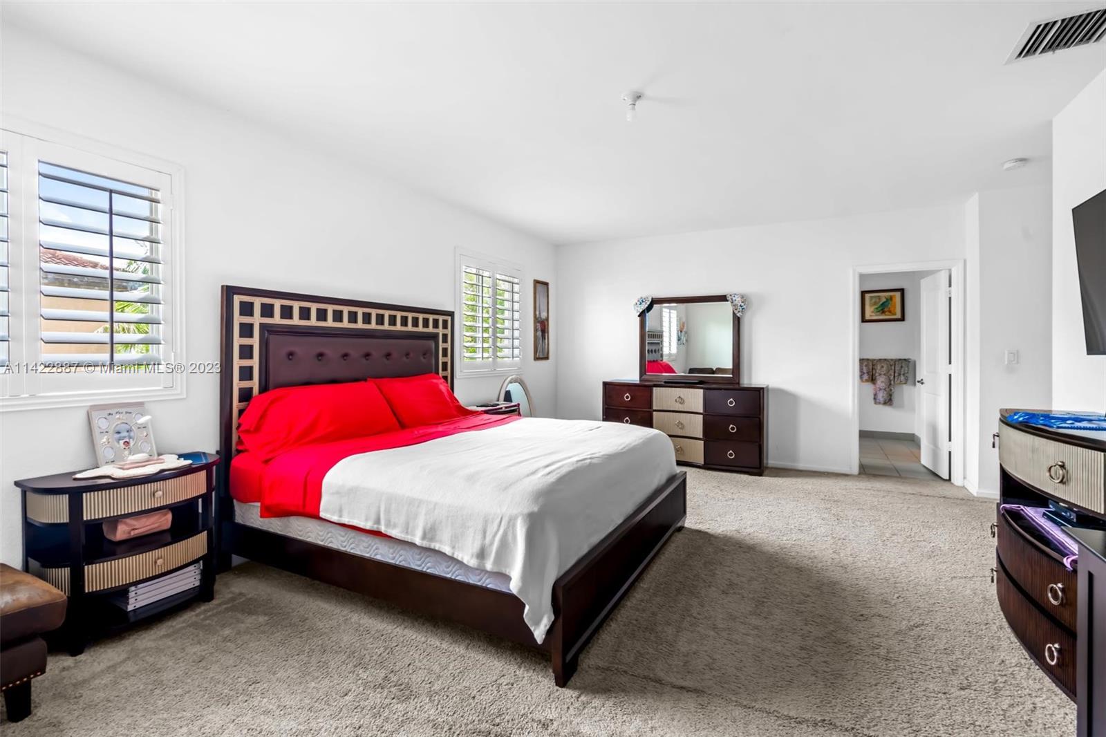 11850 Southwest 250th Terrace Homestead, FL 33032 - Photo 32 of 47 a bedroom with a bed and a flat tv screen on dresser