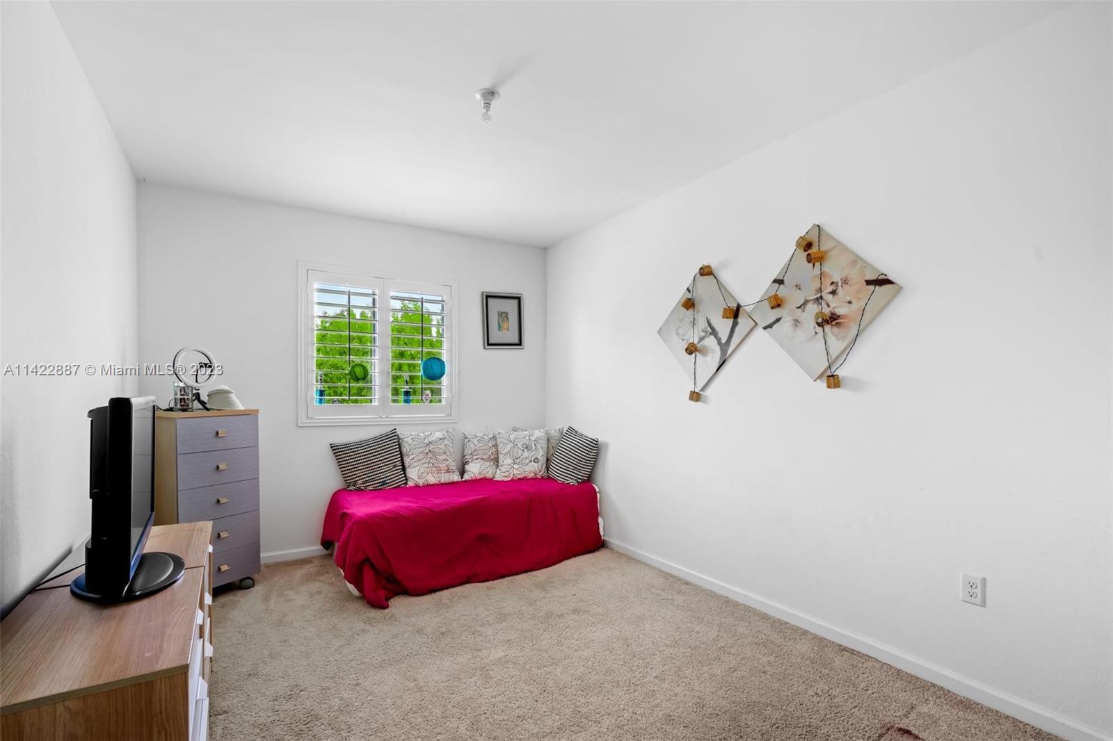 11850 Southwest 250th Terrace Homestead, FL 33032 - Photo 35 of 47 a bedroom with a bed and a window