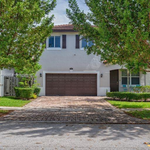 11850 Southwest 250th Terrace Homestead, FL 33032 - Photo 4 of 47 a front view of a house with a yard and garage