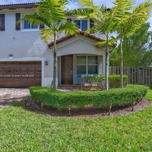 11850 Southwest 250th Terrace Homestead, FL 33032 - Photo 7 of 47 a front view of a house with garden