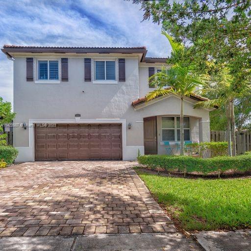 11850 Southwest 250th Terrace Homestead, FL 33032 - Photo 9 of 47 a front view of a house with a garden and trees