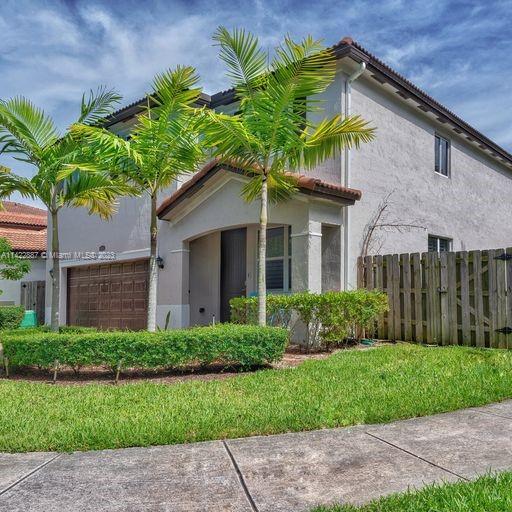 11850 Southwest 250th Terrace Homestead, FL 33032 - Photo 10 of 47 a front view of a house with a garden
