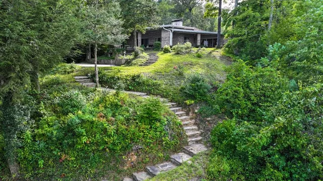 a backyard of a house with fire pit and outdoor seating