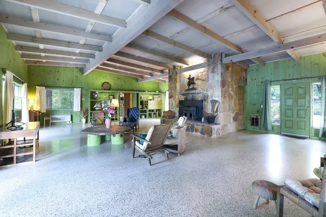 a kitchen with stainless steel appliances kitchen island granite countertop a refrigerator and a sink