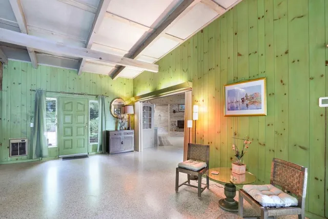 a dining table with chairs and a potted plant