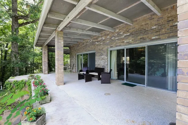 a spacious bedroom with a bed and a chandelier