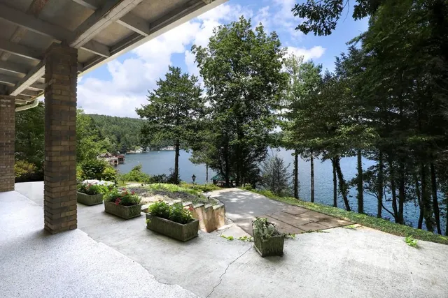 a view of a wooden balcony with a yard