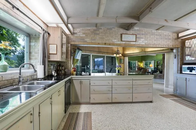 a bathroom with a double vanity sink mirror and toilet