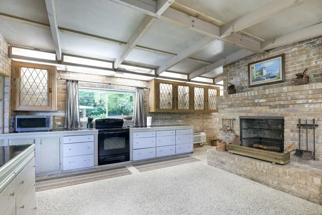 a kitchen with a sink cabinets and appliances