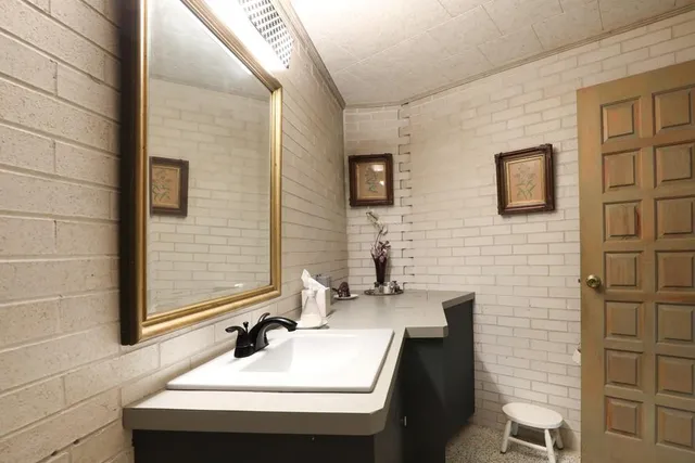 a aerial view of a house with a yard and large trees