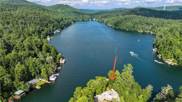a front view of a house with a yard and potted plants