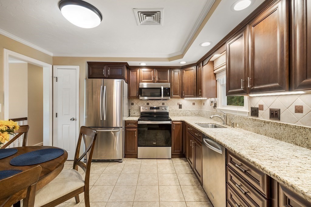 27 Phyllis Road Raynham, MA 02767 - Photo 11 of 42 a kitchen with stainless steel appliances granite countertop a sink stove and refrigerator