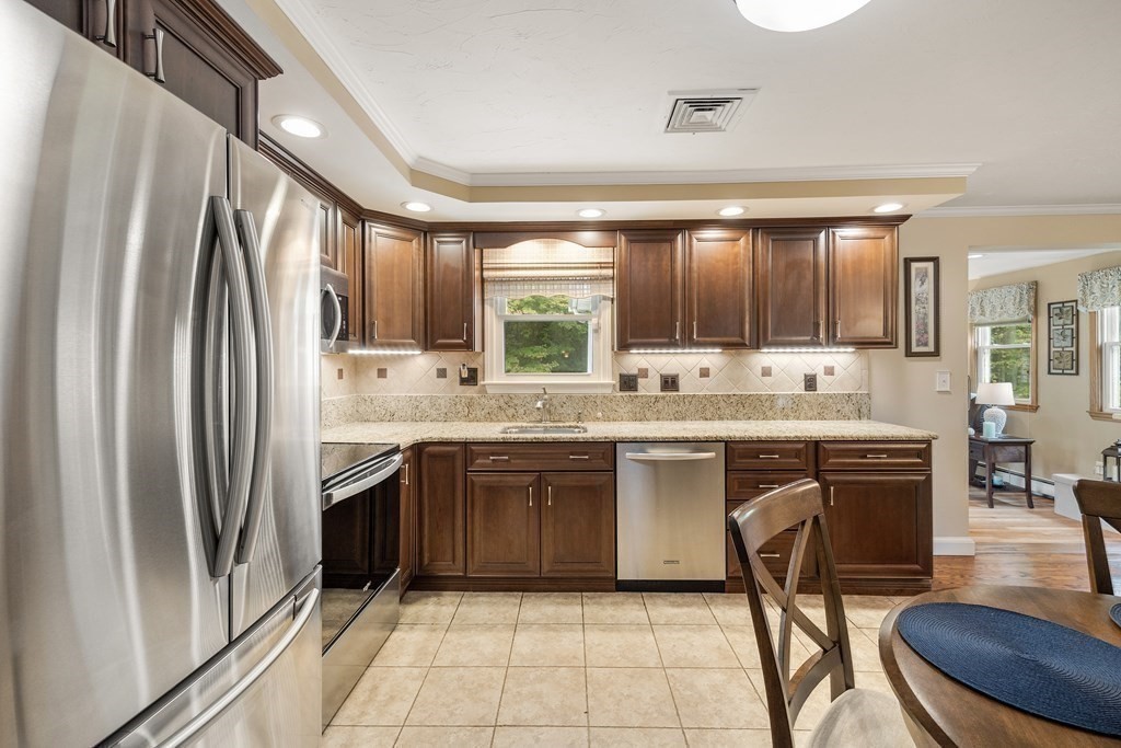 27 Phyllis Road Raynham, MA 02767 - Photo 13 of 42 a kitchen with stainless steel appliances granite countertop a refrigerator and a stove top oven