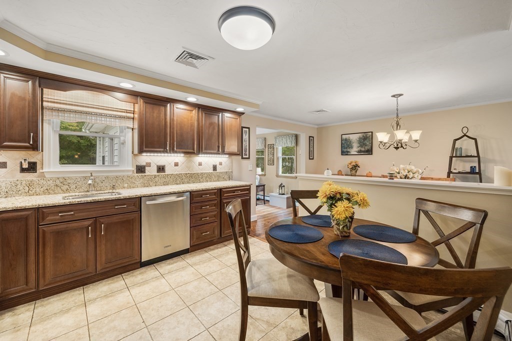 27 Phyllis Road Raynham, MA 02767 - Photo 14 of 42 a kitchen with granite countertop a sink cabinets and stove