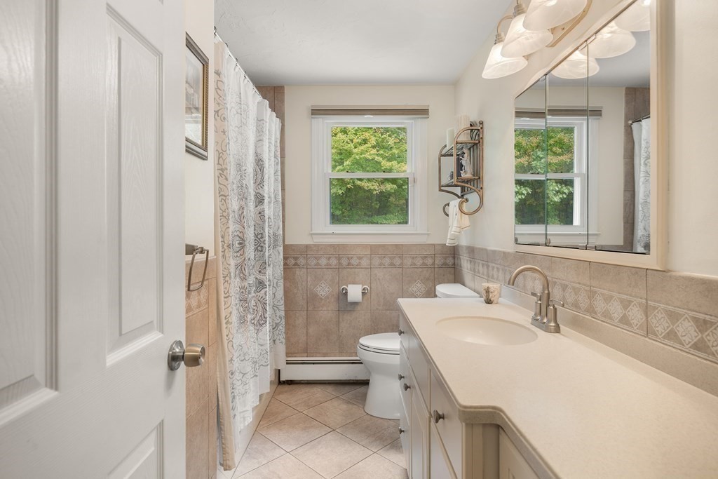 27 Phyllis Road Raynham, MA 02767 - Photo 19 of 42 a bathroom with a sink and a mirror
