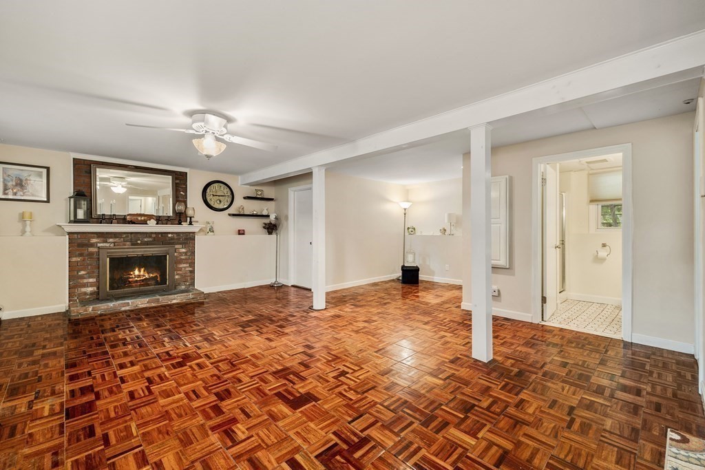 27 Phyllis Road Raynham, MA 02767 - Photo 26 of 42 a view of a livingroom with a fireplace a sink and a chandelier