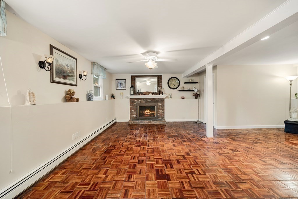 27 Phyllis Road Raynham, MA 02767 - Photo 27 of 42 a big room with chandelier fan and fireplace