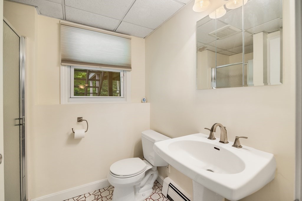 27 Phyllis Road Raynham, MA 02767 - Photo 30 of 42 a bathroom with a sink and mirror with toilet