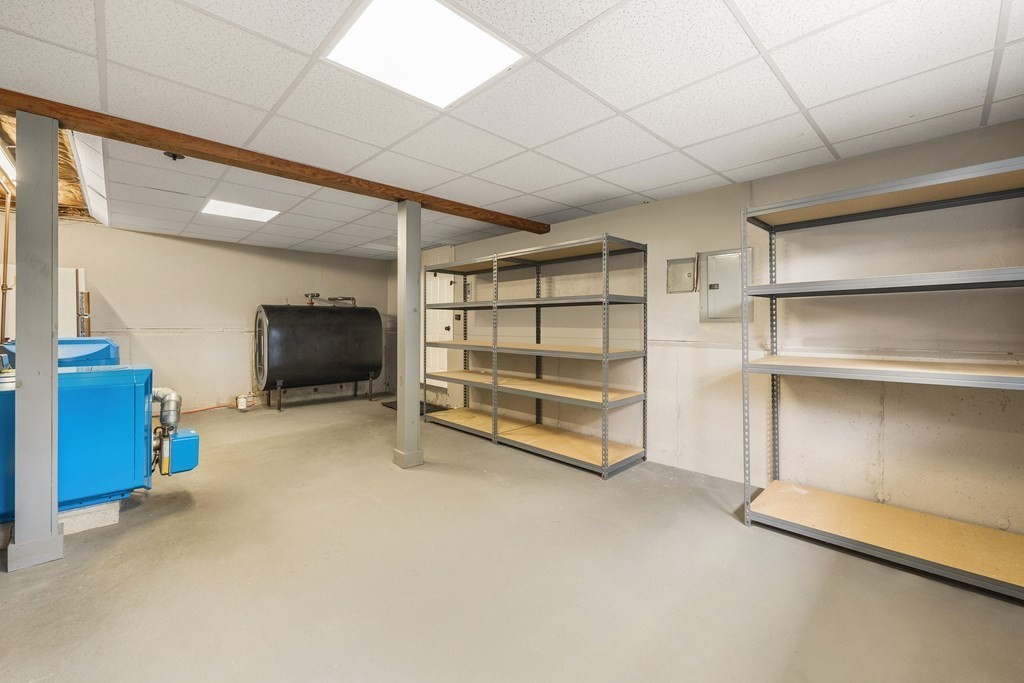 27 Phyllis Road Raynham, MA 02767 - Photo 32 of 42 a view of a room with racks on the wall