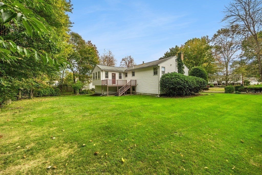 27 Phyllis Road Raynham, MA 02767 - Photo 36 of 42 a view of a house with a big yard and potted plants and large trees