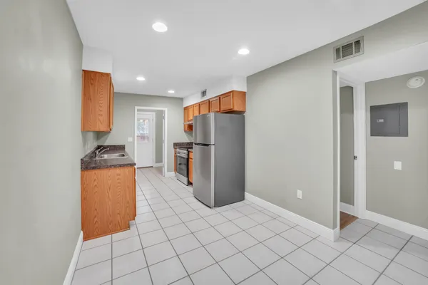 a view of a hallway with white walls and a white door