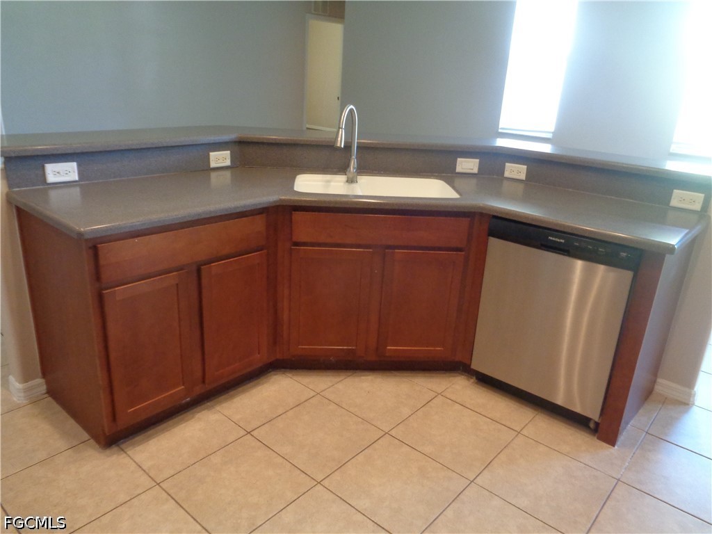 2463 Nature Pointe Loop Fort Myers, FL 33905 - Photo 16 of 50 a kitchen with a sink and cabinets
