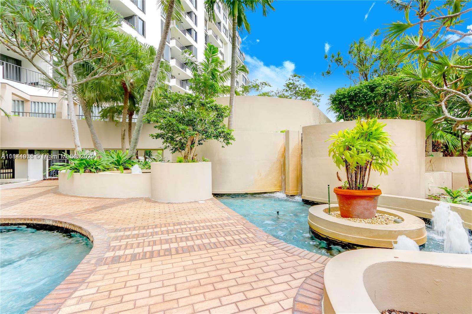 520 Brickell Key Drive, Unit A913 Miami, FL 33131 - Photo 17 of 18 a wooden bench sitting in front of a building